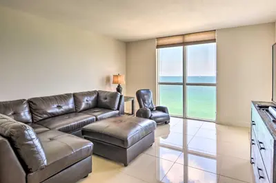 a living room with a couch and a chair at Beachfront Condo with Pool Access in Hollywood! in Hollywood