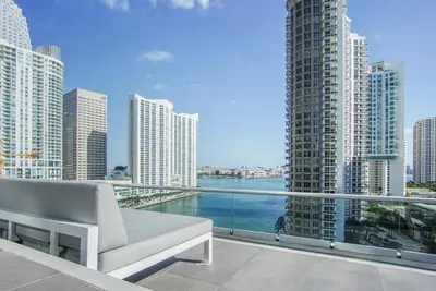 a balcony with a view of the water and buildings at NEW!!! W Brickell Miami- ICON DELUXE LOUNGE with 2 masters in Miami