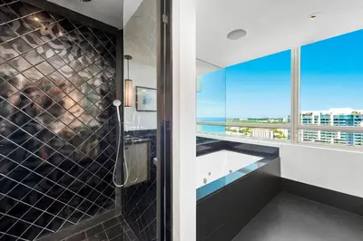 a bathroom with a shower with a view of the ocean at Oceanview Private Condo at The Setai -2401 in Miami Beach