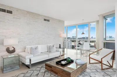 a living room with a couch and a table at Oceanview Private Condo at The Setai -2401 in Miami Beach