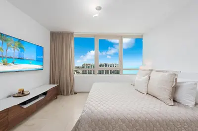 a bedroom with a large bed and a large window at Oceanview Private Condo at The Setai -2401 in Miami Beach