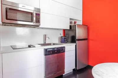 a kitchen with a microwave and a refrigerator at Blanc Kara- Adults Only in Miami Beach