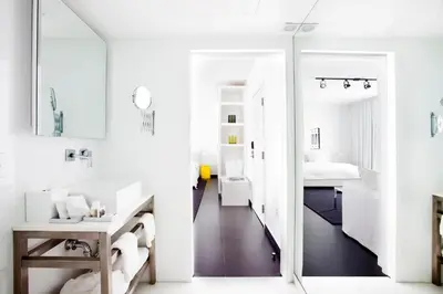 a white bathroom with a mirror and a sink at Blanc Kara- Adults Only in Miami Beach