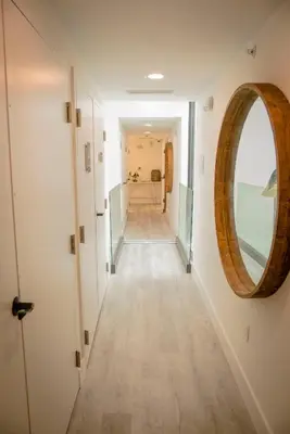 a hallway with a round mirror on the wall at Casa Sofi in Miami Beach