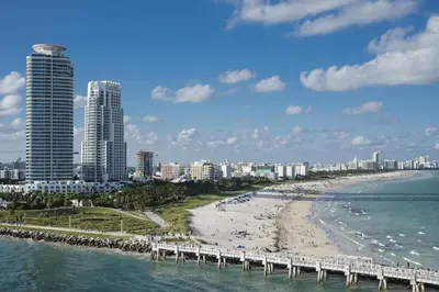a view of a beach with buildings and a pier at Casa Sofi in Miami Beach