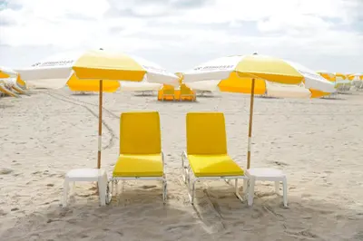 a group of chairs and umbrellas on a beach at Casa Sofi in Miami Beach