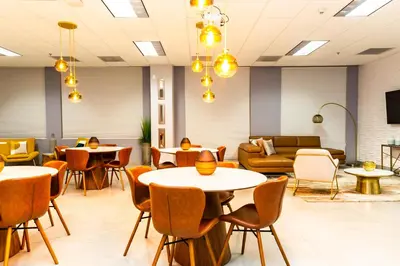 a waiting room with tables and couches at Star Stay Miami Orange Brickell in Miami