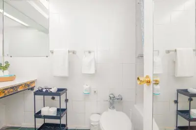 a bathroom with a toilet and a mirror at Girasole Apartments in Miami Beach