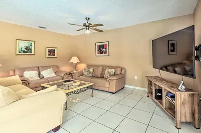 a living room with couches and a flat screen tv at Home with Pool in Upscale Pinecrest Village in Miami