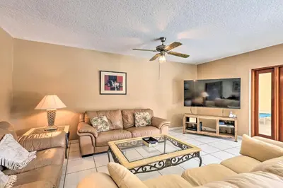 a living room with couches and a tv at Home with Pool in Upscale Pinecrest Village in Miami