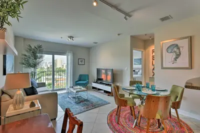 a living room with a table and a couch at Miami Apartment by Coral Gables - Great Location! in Miami