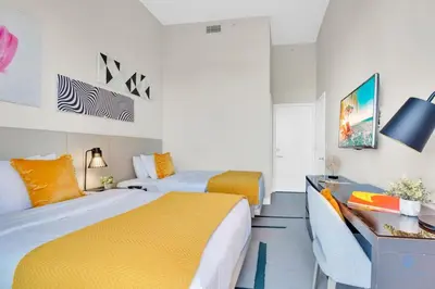 a hotel room with two beds and a desk at Luxury Amenities, Infinity Pool, Gym, Hot Tub in Hollywood