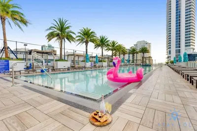 a pool with a pink flamingo pool noodle in the middle at Luxury Amenities, Infinity Pool, Gym, Hot Tub in Hollywood