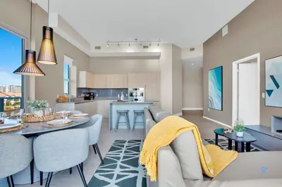a living room with a table and chairs and a kitchen at Luxury Amenities, Infinity Pool, Gym, Hot Tub in Hollywood