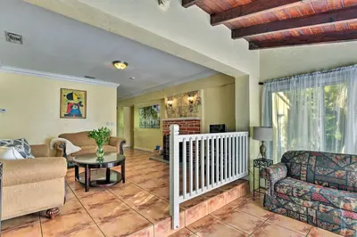 a living room with a couch and a table at Quaint Central Miami Bungalow 10 Mi to Mid-Beach! in Miami
