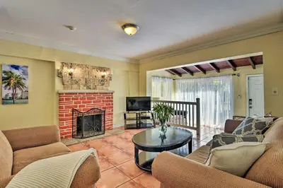 a living room with a couch and a fireplace at Quaint Central Miami Bungalow 10 Mi to Mid-Beach! in Miami