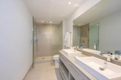 a bathroom with two sinks and a toilet and a mirror at Hyde Beach House Luxury Condo-Resort 1204 condo in Hollywood Beach
