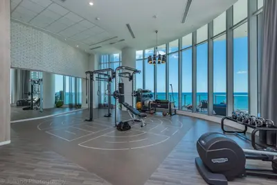 a gym with cardio equipment in a building with windows at Hyde Beach House Luxury Condo-Resort 1204 condo in Hollywood Beach