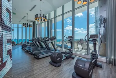 a gym with a bunch of treadmills and windows at Hyde Beach House Luxury Condo-Resort 1204 condo in Hollywood Beach