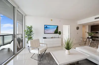a living room with white furniture and a view of the ocean at ICON BRICKELL-29th FLOOR OCEAN VIEWS-FREE SPA in Miami