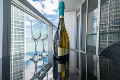 a bottle of wine and two wine glasses on a table at ICON BRICKELL-29th FLOOR OCEAN VIEWS-FREE SPA in Miami