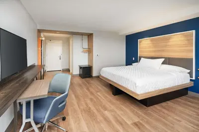 a bedroom with a bed and a desk and a chair at Tru By Hilton Ft Lauderdale Airport in Dania Beach