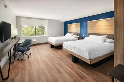 a hotel room with two beds and a desk and a chair at Tru By Hilton Ft Lauderdale Airport in Dania Beach