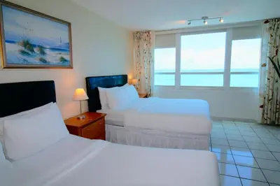 a hotel room with two beds and a window at Castle 1733 Ocean view studio with direct beach access, pool, tennis & free parking in Miami Beach