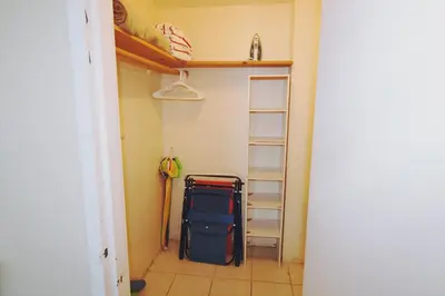 a room with a closet with luggage and a shelf at Castle 1733 Ocean view studio with direct beach access, pool, tennis & free parking in Miami Beach
