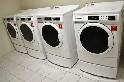 three washing machines sitting next to each other in a room at Beautiful Apartment Steps Away from the Beach in Miami Beach