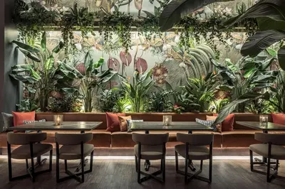 a restaurant with plants on the wall at THesis Hotel Miami Coral Gables, Curio Collection by Hilton in Miami