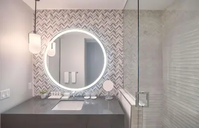 a bathroom with a sink and a mirror at THesis Hotel Miami Coral Gables, Curio Collection by Hilton in Miami