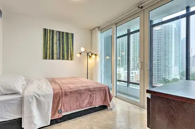 a bedroom with a bed and a large window at Waterfront High-Rise Condo - Miami Beach 5 Mi in Miami
