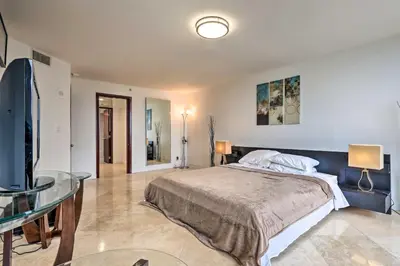 a bedroom with a bed and a glass table at Waterfront High-Rise Condo - Miami Beach 5 Mi in Miami
