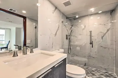 a bathroom with a shower and a sink and a toilet at Waterfront High-Rise Condo - Miami Beach 5 Mi in Miami