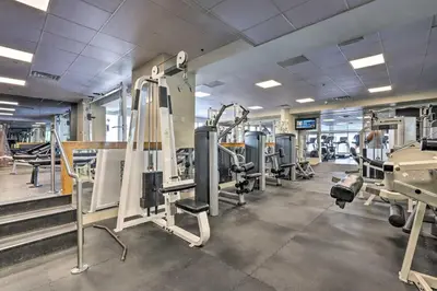 a gym with treadmills and tread machines at Waterfront High-Rise Condo - Miami Beach 5 Mi in Miami