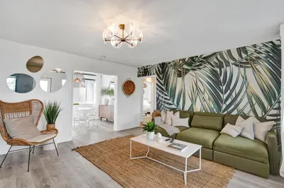 a living room with a green couch and a table at Lincoln Villa Suites in Miami Beach