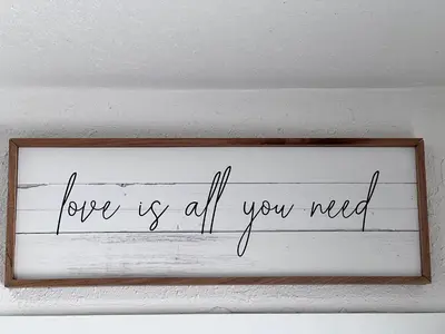 a sign that says love is all you need on a wall at Stylish Studio Apartment By Miami International Airport in Miami