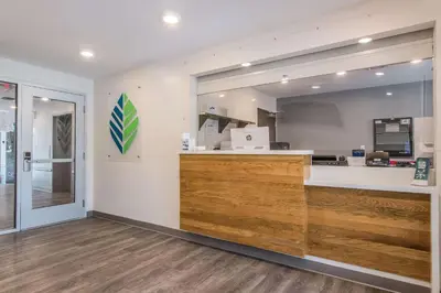 a kitchen with a counter and a large mirror at WoodSpring Suites Doral Miami Airport in Miami