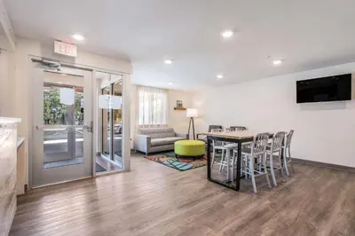a kitchen and living room with a table and chairs at WoodSpring Suites Doral Miami Airport in Miami
