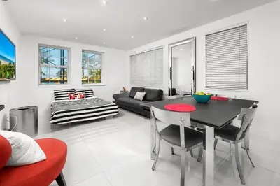 a living room with a black table and chairs at South Beach Suites in Ocean Drive in Miami Beach