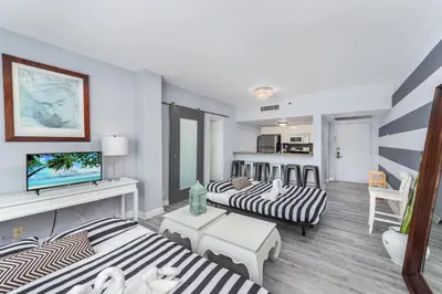 a living room with two beds and a couch at South Beach Suites in Ocean Drive in Miami Beach