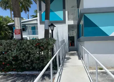 a walkway leading to the front of a building at Rolo Beach Hotel in Fort Lauderdale