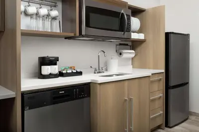 a kitchen with a sink and a microwave at Home2 Suites By Hilton Miami Doral West Airport, Fl in Miami