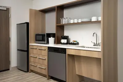a kitchen with a sink and a black refrigerator at Home2 Suites By Hilton Miami Doral West Airport, Fl in Miami