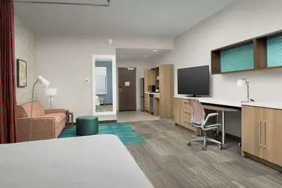 a hotel room with a desk and a tv at Home2 Suites By Hilton Miami Doral West Airport, Fl in Miami