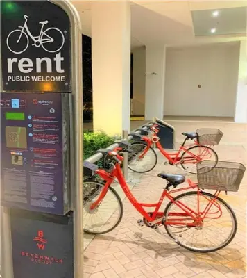 a row of bikes parked next to a sign at Bposhtels Hollywood Florida in Hollywood