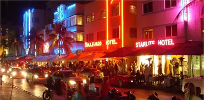 a busy city street at night with cars and people at Bposhtels Hollywood Florida in Hollywood