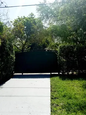 a gate in the middle of a yard at FAMILY Guayabita's House in Miami