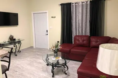 a living room with a red couch and a table at Your House in Miami in Miami